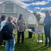 The farm manager along with a professor speak about the SAP's compost usage to a group of interested students and community members.